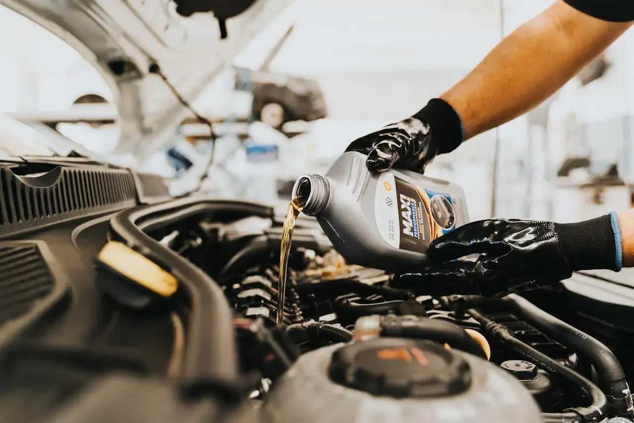 Technician changing pouring new engine oil